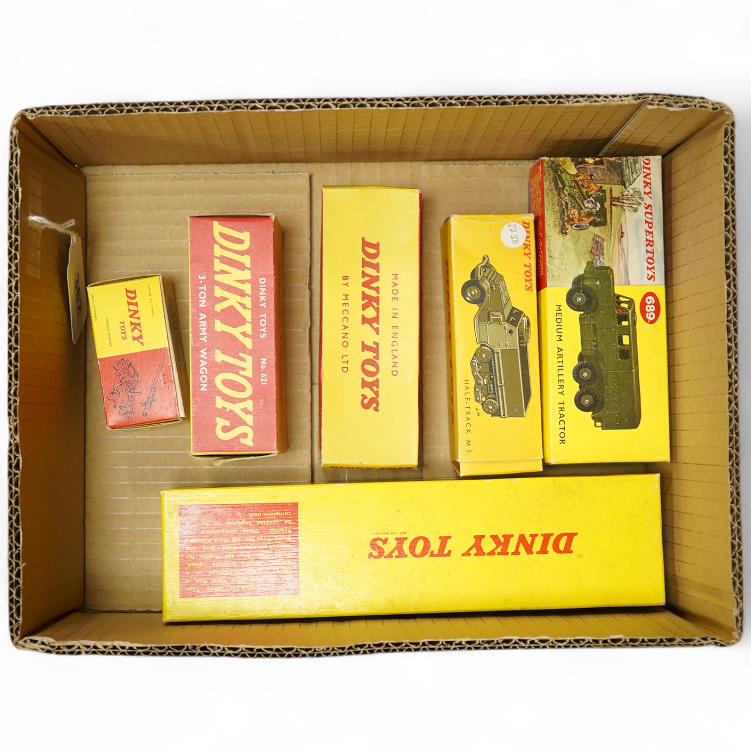 Six boxed Dinky Toys and French Dinky Toys military vehicles; a 25-pounder Field Gun set (697), Half-Track M3 (822) with machine gun, Jeep avec Canon (829) (gun missing), Medium Artillery Tractor (689), and 5.5 medium gu
